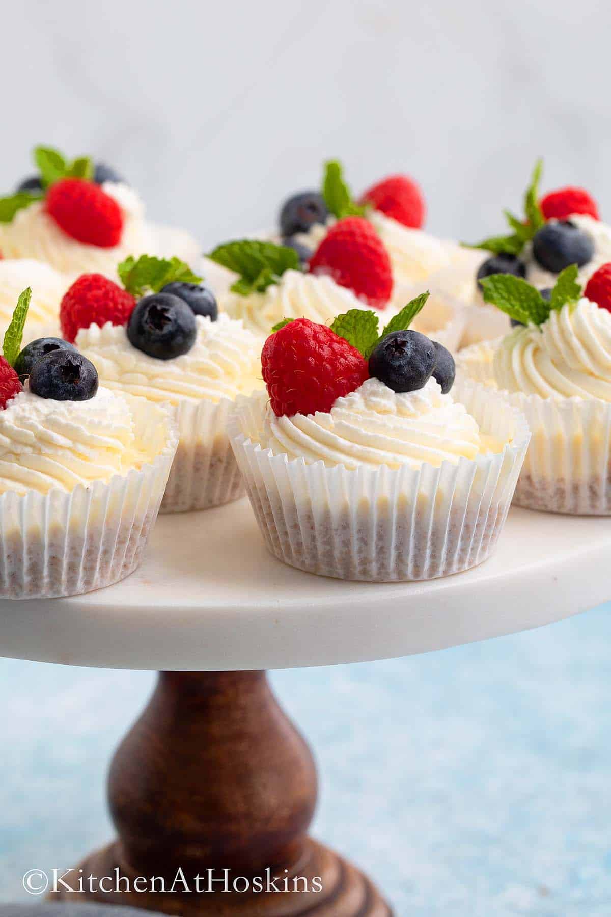 mini cheesecakes on a round cake stand.