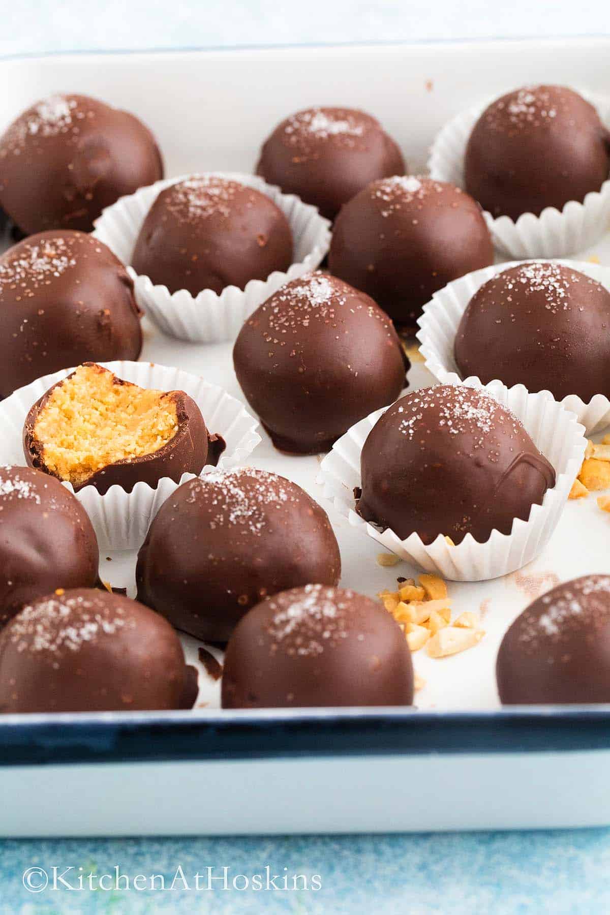 chocolate covered peanut butter balls placed in a white tray.