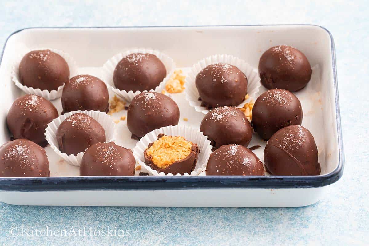 rectangular tray with chocolate coated peanut butter balls.