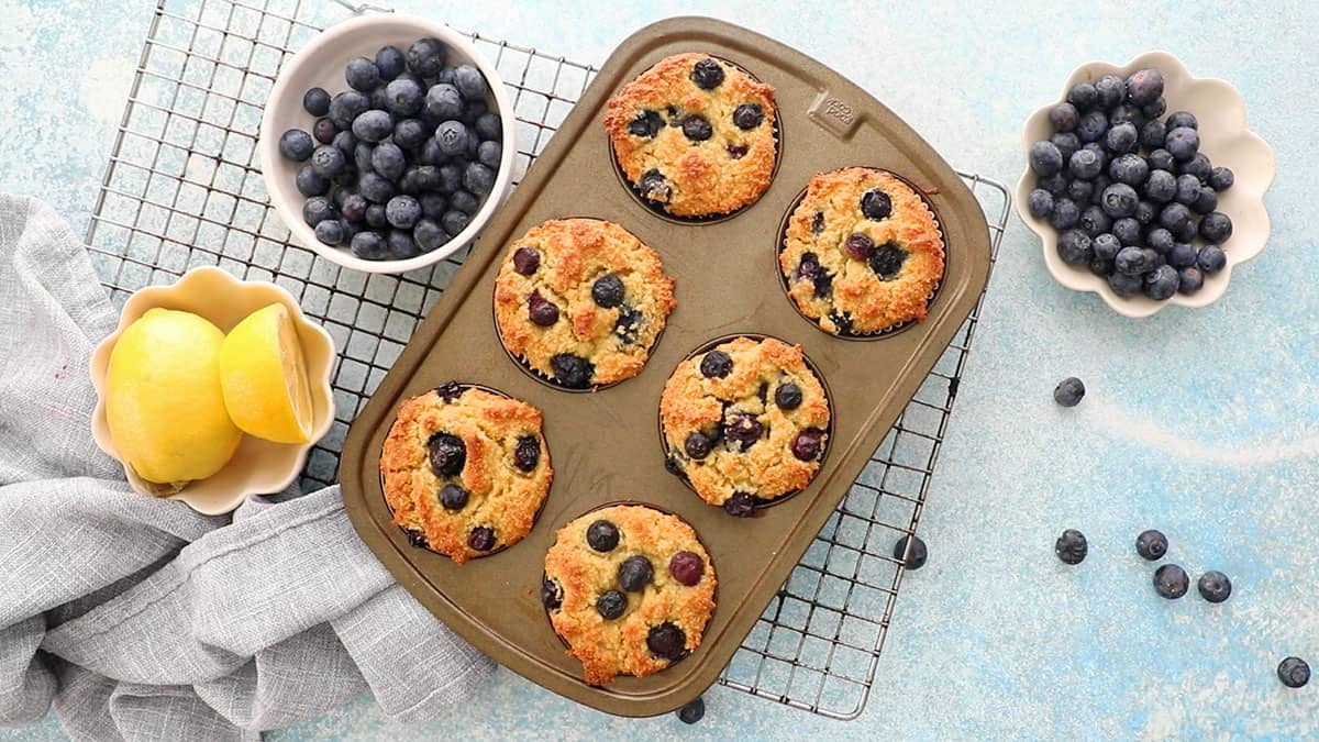 one metal muffin pan with 6 lemon blueberry muffins.