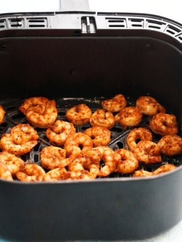 cooked Mexican shrimp in an air fryer basket.