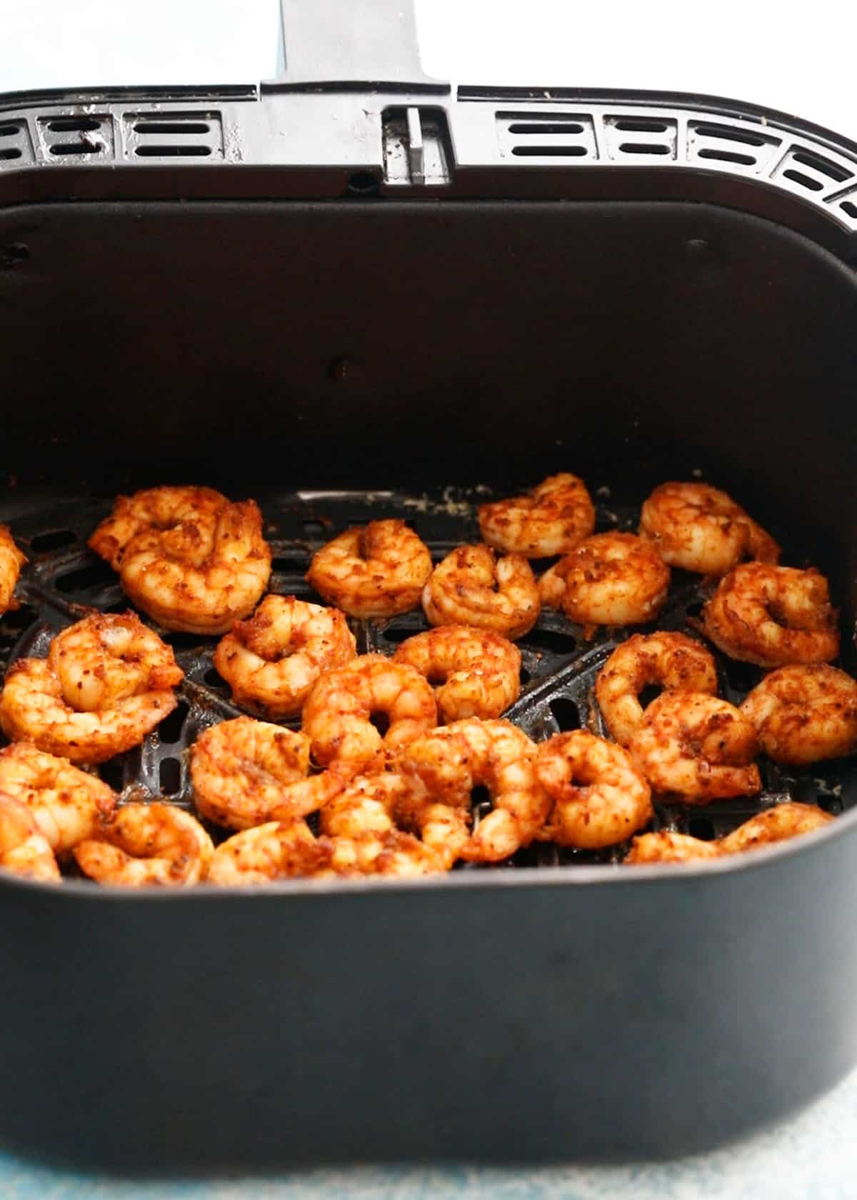 cooked Mexican shrimp in an air fryer basket.