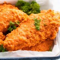 buffalo chicken tenders on a white tray.