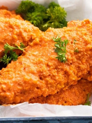 buffalo chicken tenders on a white tray.