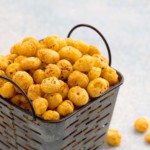 spicy roasted makhana piled high on a metal basket.
