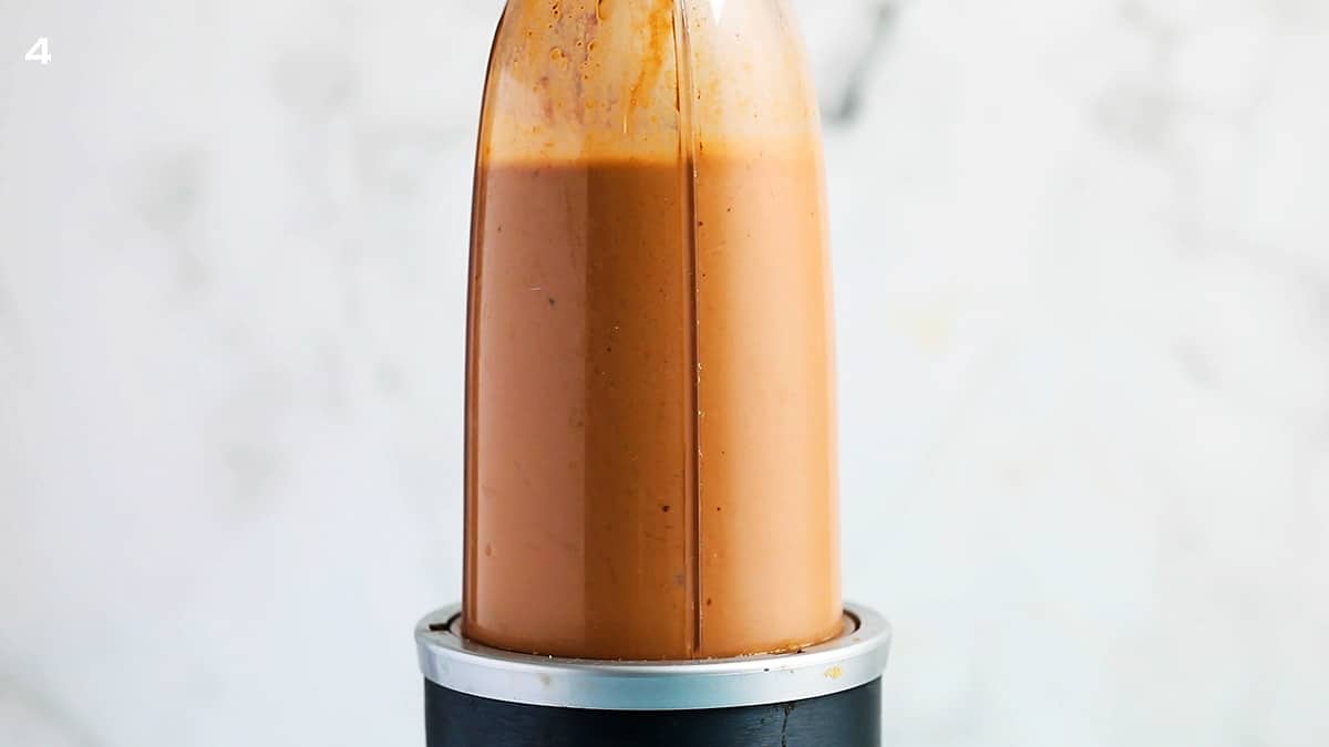 a blender blending brown smoothie.