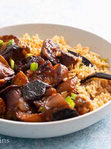 white bowl with rice and cooked eggplant.