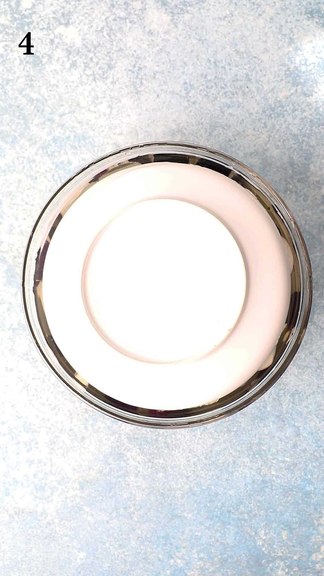 glass bowl topped with a white plate.  