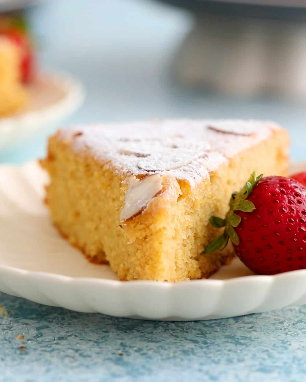 one slice of almond flour cake in a white plate.