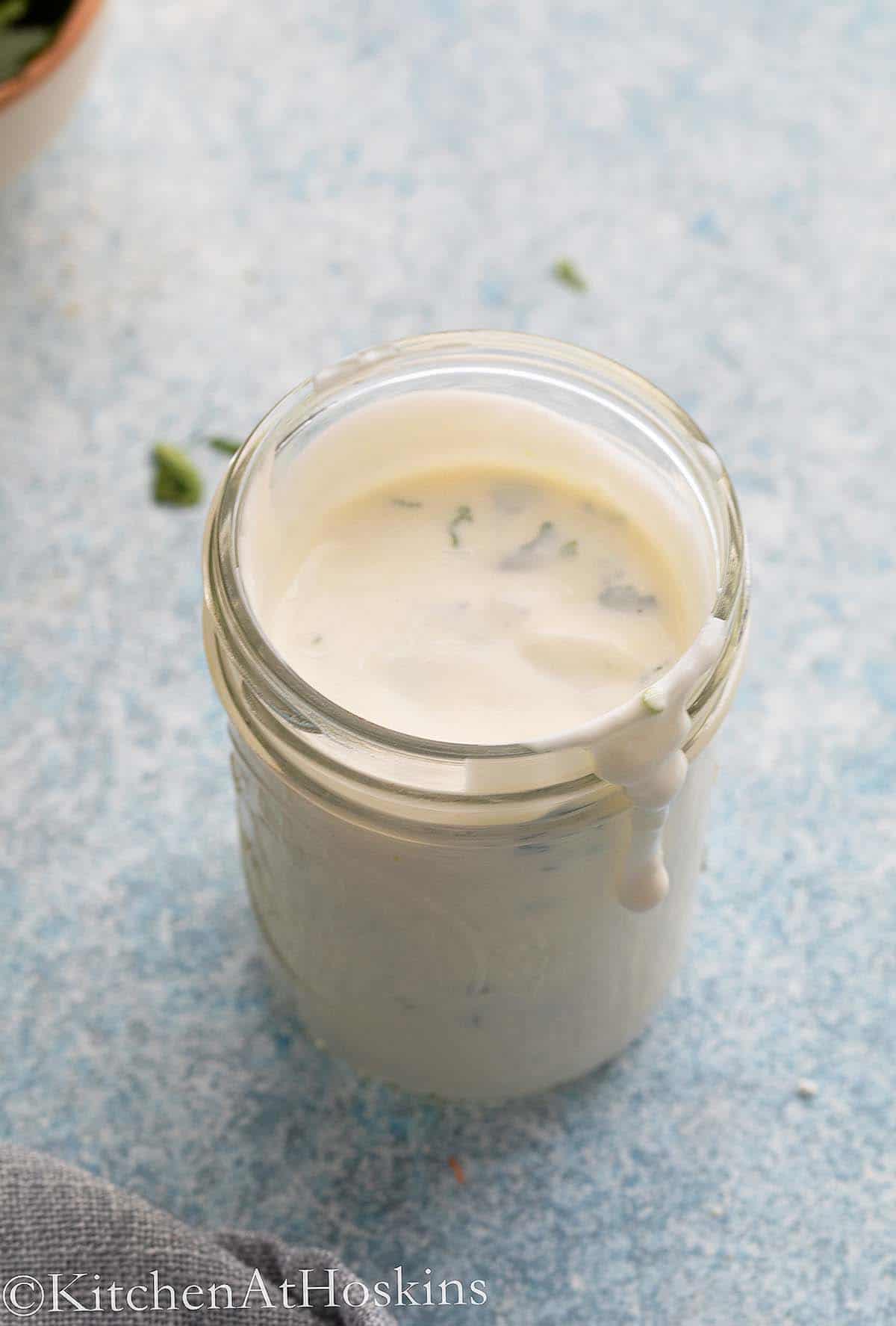glass jar filled with greek yogurt sauce.