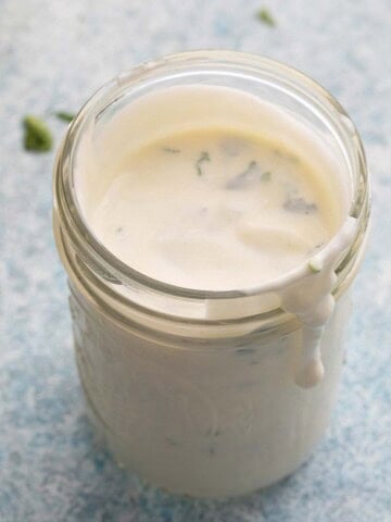 white yogurt sauce in a glass jar.