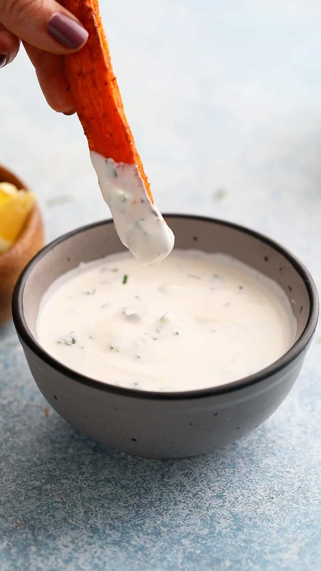 partially dipped carrot fry in white yogurt sauce.