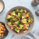 broccoli cashew cranberry salad in a grey bowl.