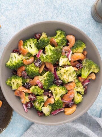 broccoli cashew cranberry salad in a grey bowl.