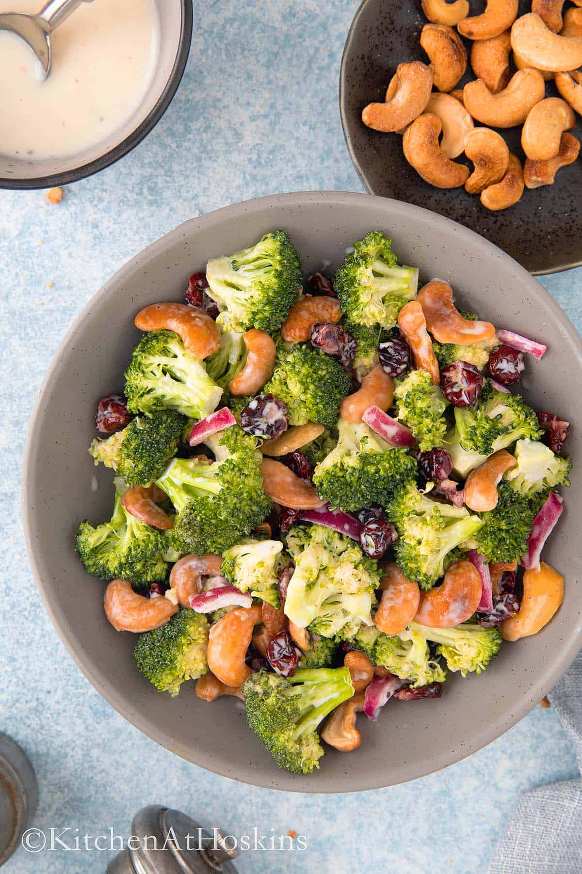 grey bowl with broccoli cranberry cashew salad.