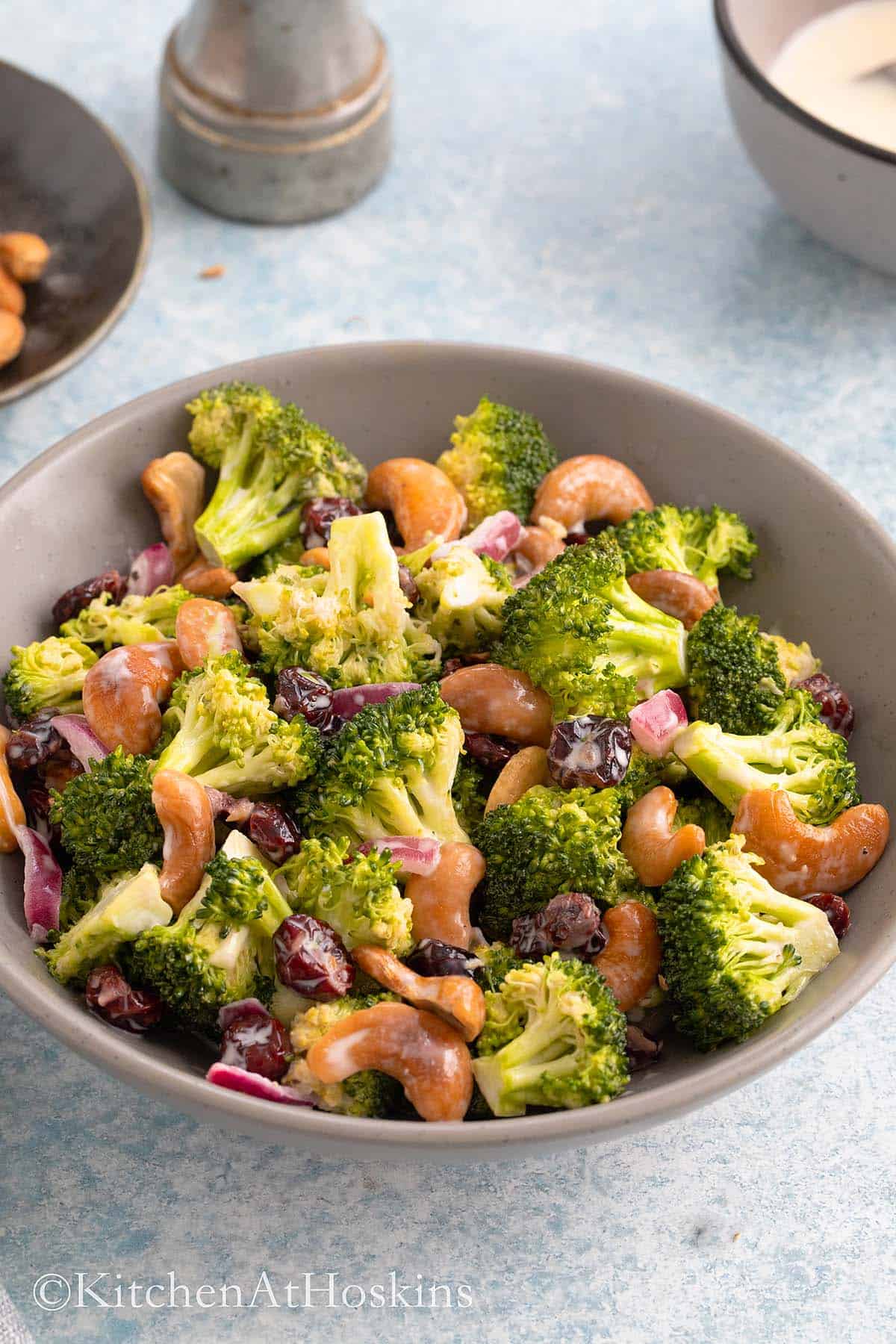 broccoli and cashew salad in a grey round bowl.