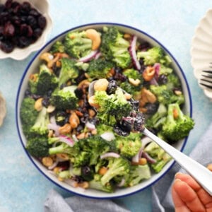 green broccoli salad in a white bowl.