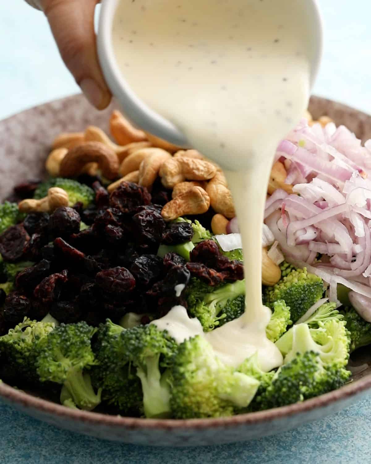 broccoli salad in a brown bowl.