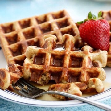 two healthy waffles on a white plate.