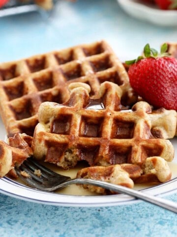 two healthy waffles on a white plate.