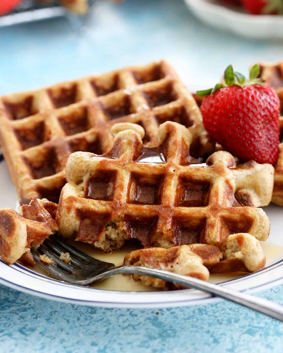 two healthy waffles on a white plate.