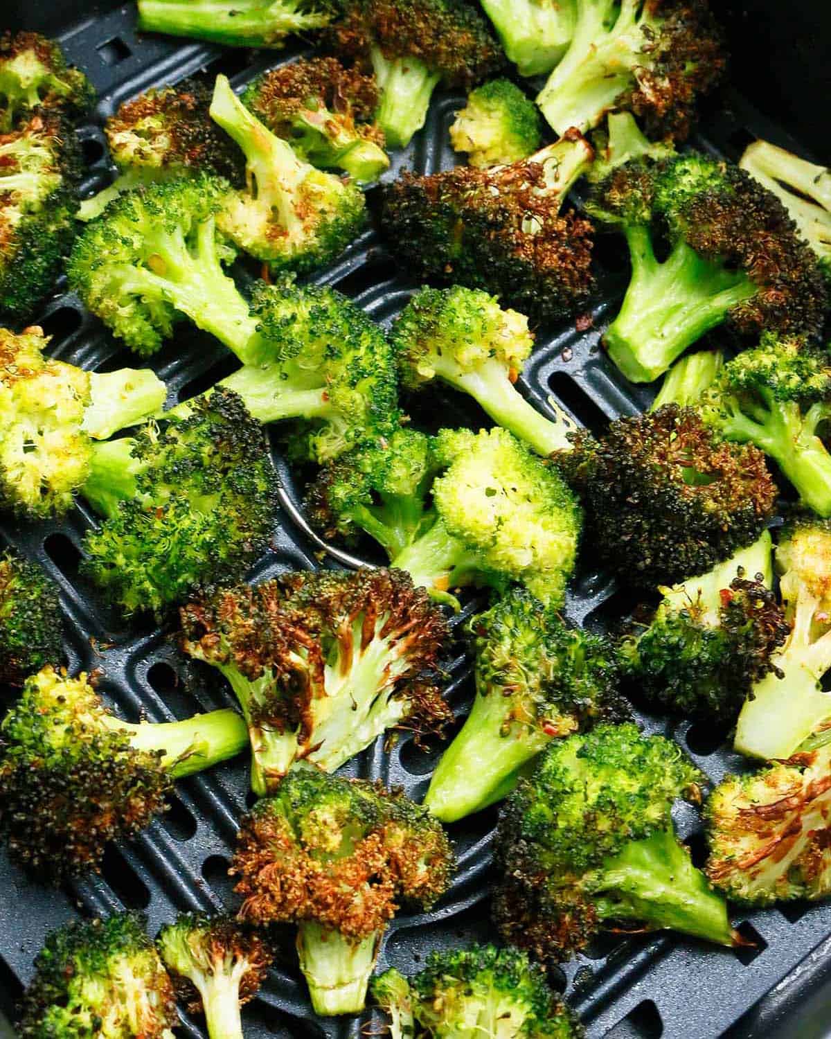 air fried broccoli in a black basket.