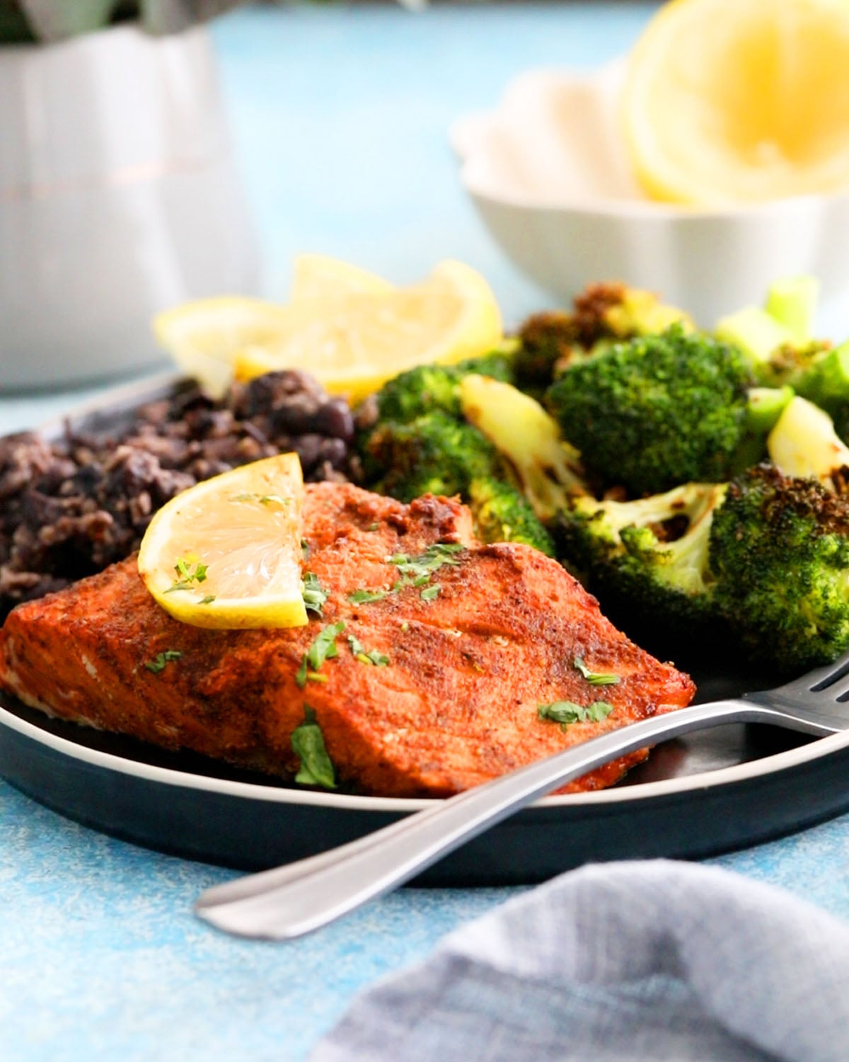 air fried salmon with green broccoli in a green plate.