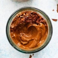 brown chocolate avocado mousse in a glass jar.
