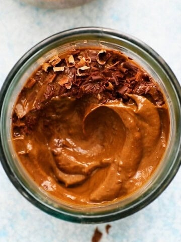 brown chocolate avocado mousse in a glass jar.