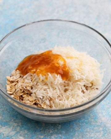coconut, almonds and oats in a glass bowl.
