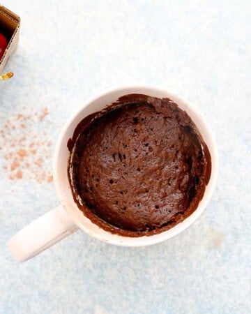 baked chocolate cake in a white mug.