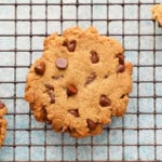 one chocolate chip cookie on a wire rack.