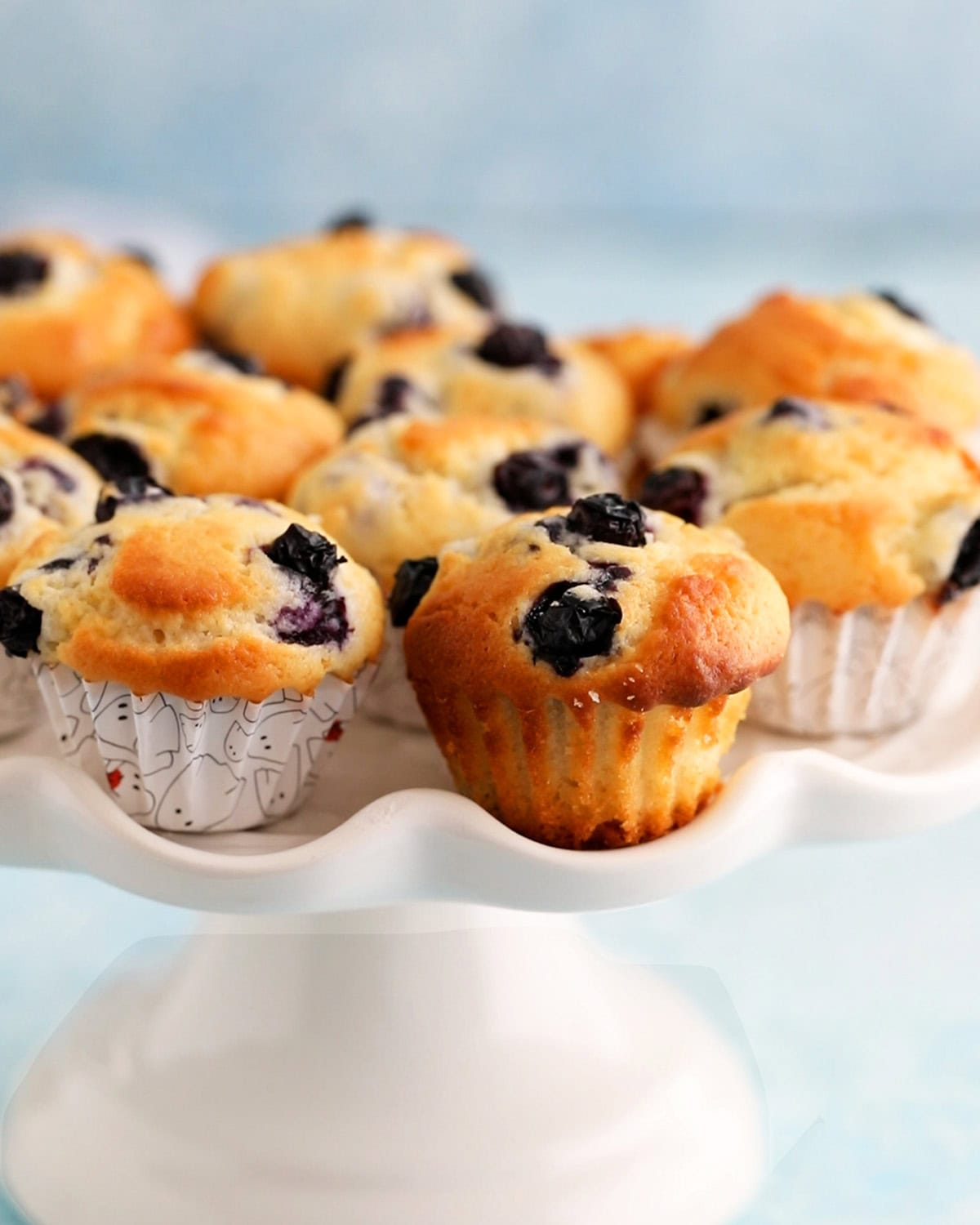 mini blueberry muffins in a white cake stand.