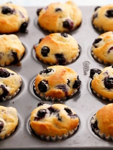 mini blueberry muffins in a metal pan.