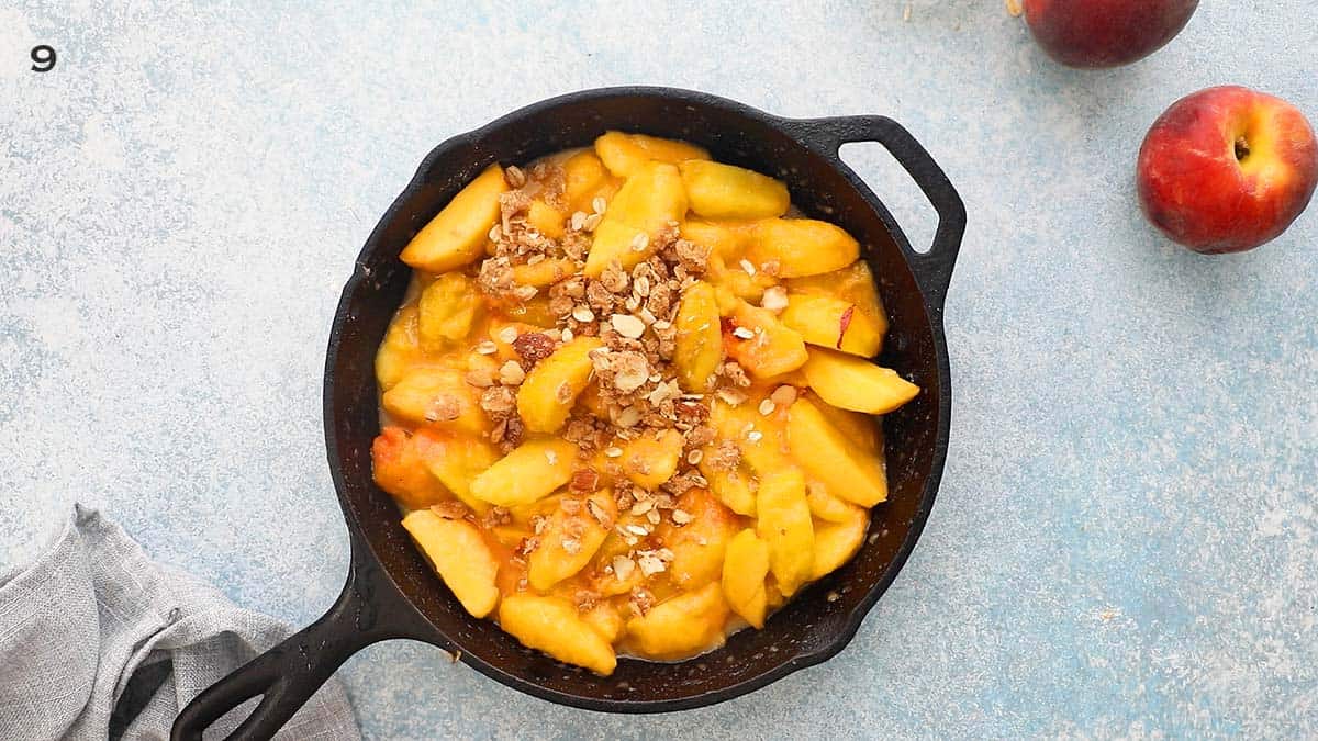 one black skillet with sliced peaches.