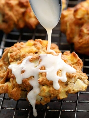 three air fried apple fritters on a wire rack.