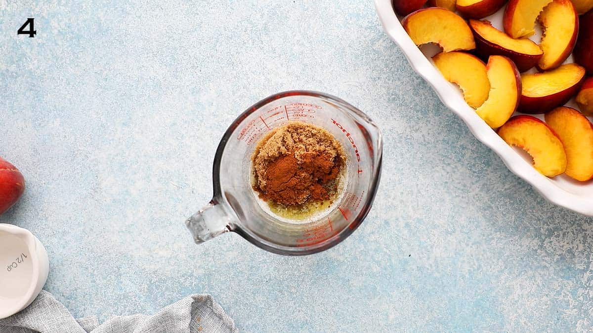 a glass measuring bowl with brown sugar and melted butter.