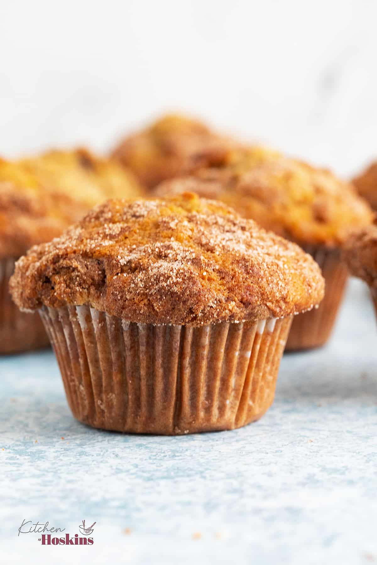 apple muffins placed on a blue board.