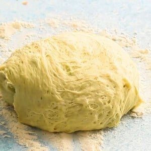 golden bread dough on a white marble.