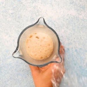 white yeast milk mixture in a glass cup.