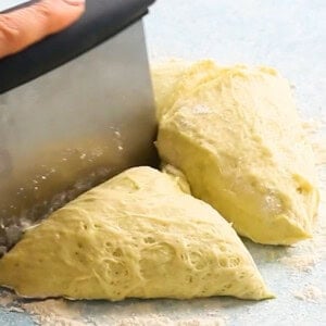 golden bread dough on a white marble.