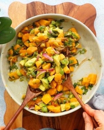 yellow and green mango avocado salsa in a white bowl.