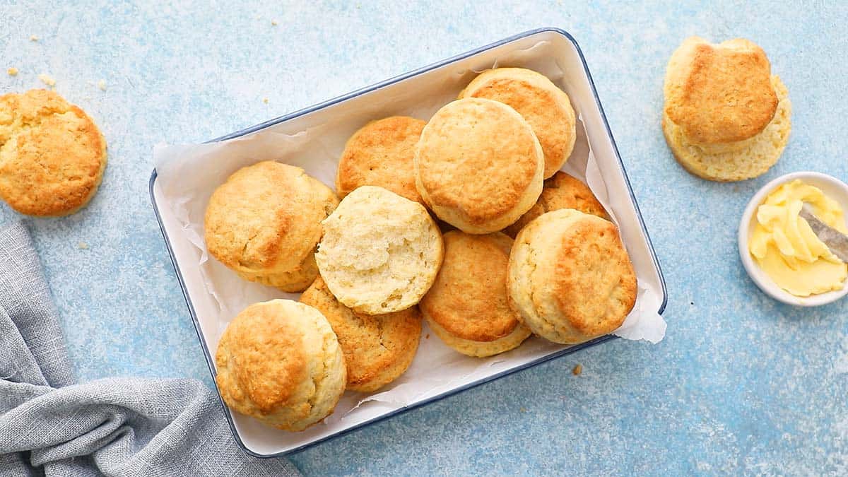 a white metal tray with baked cream biscuits.