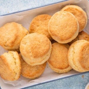 baked cream biscuits on a white metal tray.