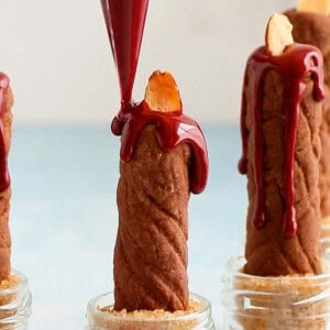 brown candle shaped cookies on a board.
