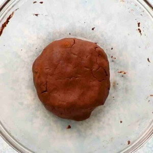 brown cookie dough in a glass bowl.