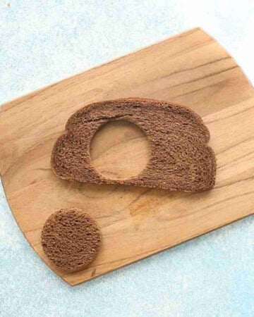 one brown bread cut outs on a wooden board.