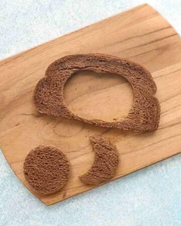 one brown bread cut outs on a wooden board.