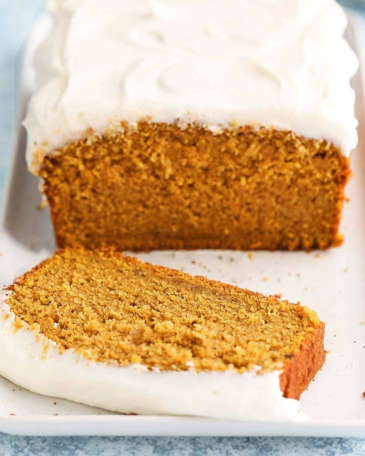 orange pumpkin cake slice in a white pan.