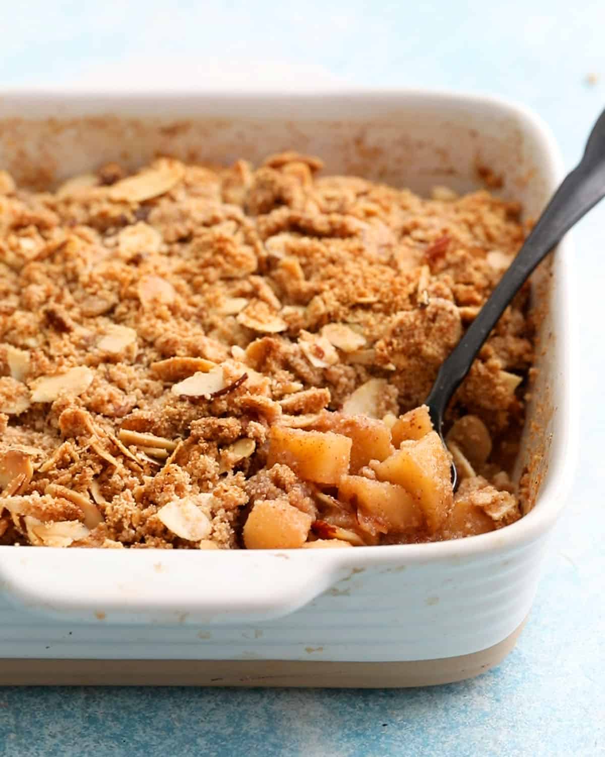 gluten free apple crumble in a white baking dish.
